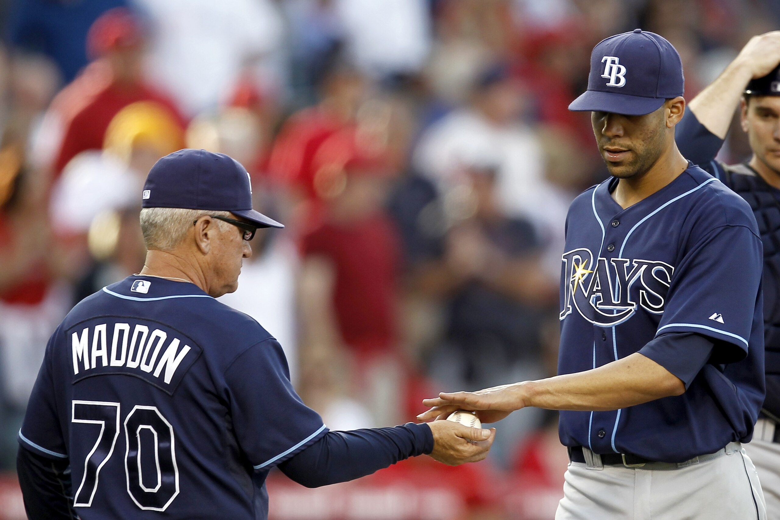 Tampa Bay Rays manager Joe Maddon, left, takes the ball from starting pitcher David Price as catcher John Jaso looks on during the seventh inning of a baseball game against the Los Angeles Angels in Anaheim, Calif., Wednesday, May 12, 2010. (AP Photo/Chris Carlson)