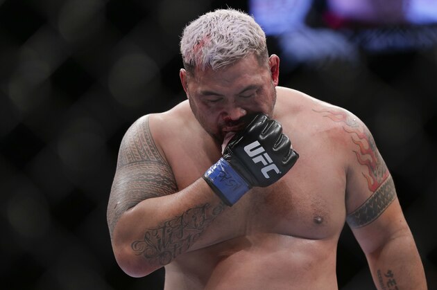Mark Hunt pulls his mouthpiece out between rounds against Junior Dos Santos during a UFC 160 mixed martial arts heavyweight bout, Saturday, May 25, 2013, in Las Vegas. Dos Santos won by knockout in the third round. (AP Photo/Julie Jacobson)