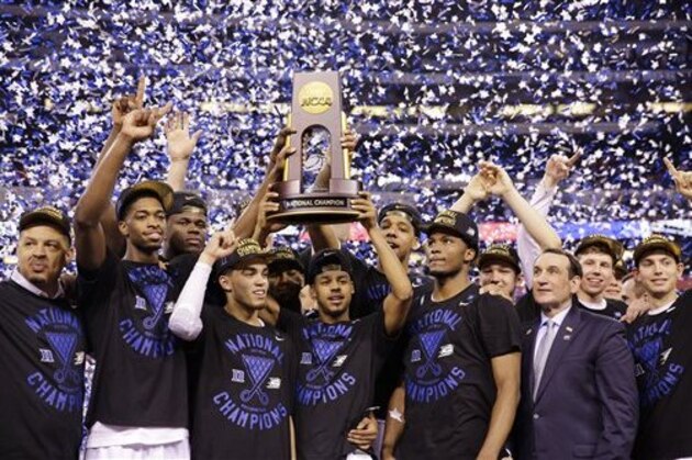 Duke players celebrate with the trophy after their 68-63 victory over Wisconsin in the NCAA Final Four college basketball tournament championship game Monday, April 6, 2015, in Indianapolis. (AP Photo/David J. Phillip)