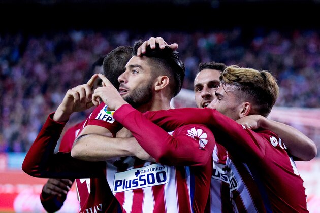 MADRID, SPAIN - OCTOBER 25:  Yannick Carrasco (L) of Atletico de Madrid celebrates scoring their second goal with teammates Antoine Griezmann (R) and Koke (2ndR) during the La Liga amtch between Club Atletico de Madrid and Valencia CF at Vicente Calderon Stadium on October 25, 2015 in Madrid, Spain.  (Photo by Gonzalo Arroyo Moreno/Getty Images)
