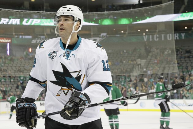 San Jose Sharks center Patrick Marleau (12) looks to give away a puck to a fan in the stands during warm ups before an NHL hockey game against the Dallas Stars Saturday, Oct. 31, 2015, in Dallas. (AP Photo/LM Otero)