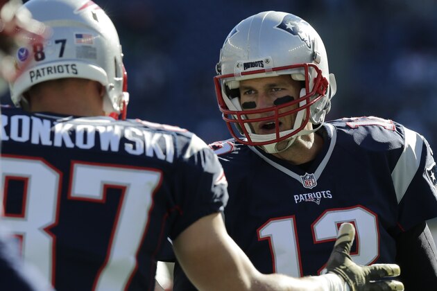New England Patriots quarterback Tom Brady (12) talks with teammate Rob Gronkowski before an NFL football game between the New England Patriots and the Washington Redskins, Sunday, Nov. 8, 2015, in Foxborough, Mass. (AP Photo/Charles Krupa)