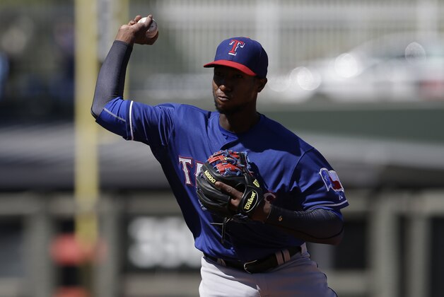 Texas Rangers' Jurickson Profar throws during a spring exhibition baseball game against the Kansas City Royals Saturday, March 22, 2014, in Surprise, Ariz. (AP Photo/Darron Cummings)
