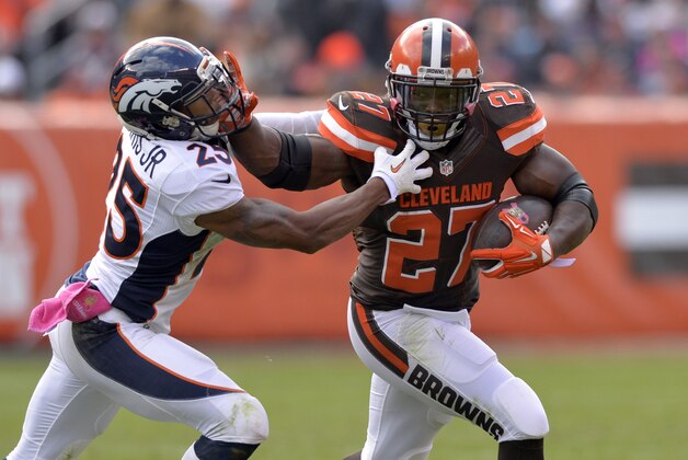 Oct 18, 2015; Cleveland, OH, USA; Cleveland Browns running back Robert Turbin (27) stiff arms Denver Broncos cornerback Chris Harris (25) during the first half at FirstEnergy Stadium. Mandatory Credit: Ken Blaze-USA TODAY Sports