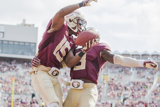Florida State wide receiver Travis Rudolph, left, celebrates with teammate Jesus Wilson after a 19 yard touchdown reception in the second half of an NCAA college football game against Syracuse in Tallahassee, Fla., Saturday, Oct. 31.  Florida State defeated Syracuse 45-21. (AP Photo/Mark Wallheiser)