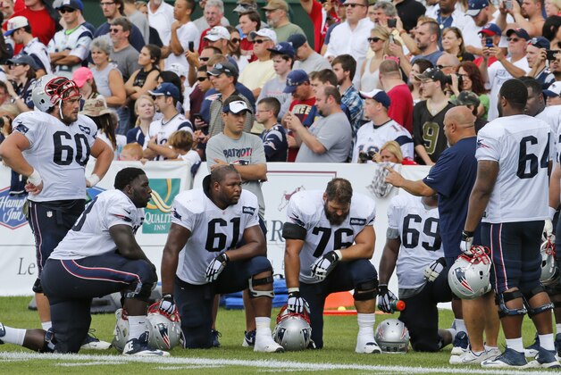 New England Patiots offensive line coach Dave DeGuglielmo, second from right, talks players in front of fans during a joint practice with the New Orleans Saints at the Saints' NFL football training camp in White Sulphur Springs, W.Va., Wednesday, Aug. 19, 2015.  (AP Photo/Steve Helber)