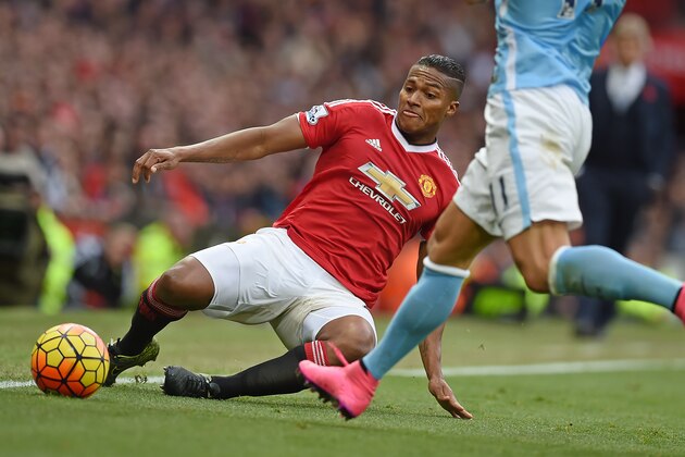 Manchester United's Ecuadorian midfielder Antonio Valencia (L) is challenged by Manchester City's Serbian defender Aleksandar Kolarov during the English Premier League football match between Manchester United and Manchester City at Old Trafford in Manchester, north west England, on October 25, 2015.  AFP PHOTO / PAUL ELLIS

RESTRICTED TO EDITORIAL USE. No use with unauthorized audio, video, data, fixture lists, club/league logos or 'live' services. Online in-match use limited to 75 images, no video emulation. No use in betting, games or single club/league/player publications.        (Photo credit should read PAUL ELLIS/AFP/Getty Images)