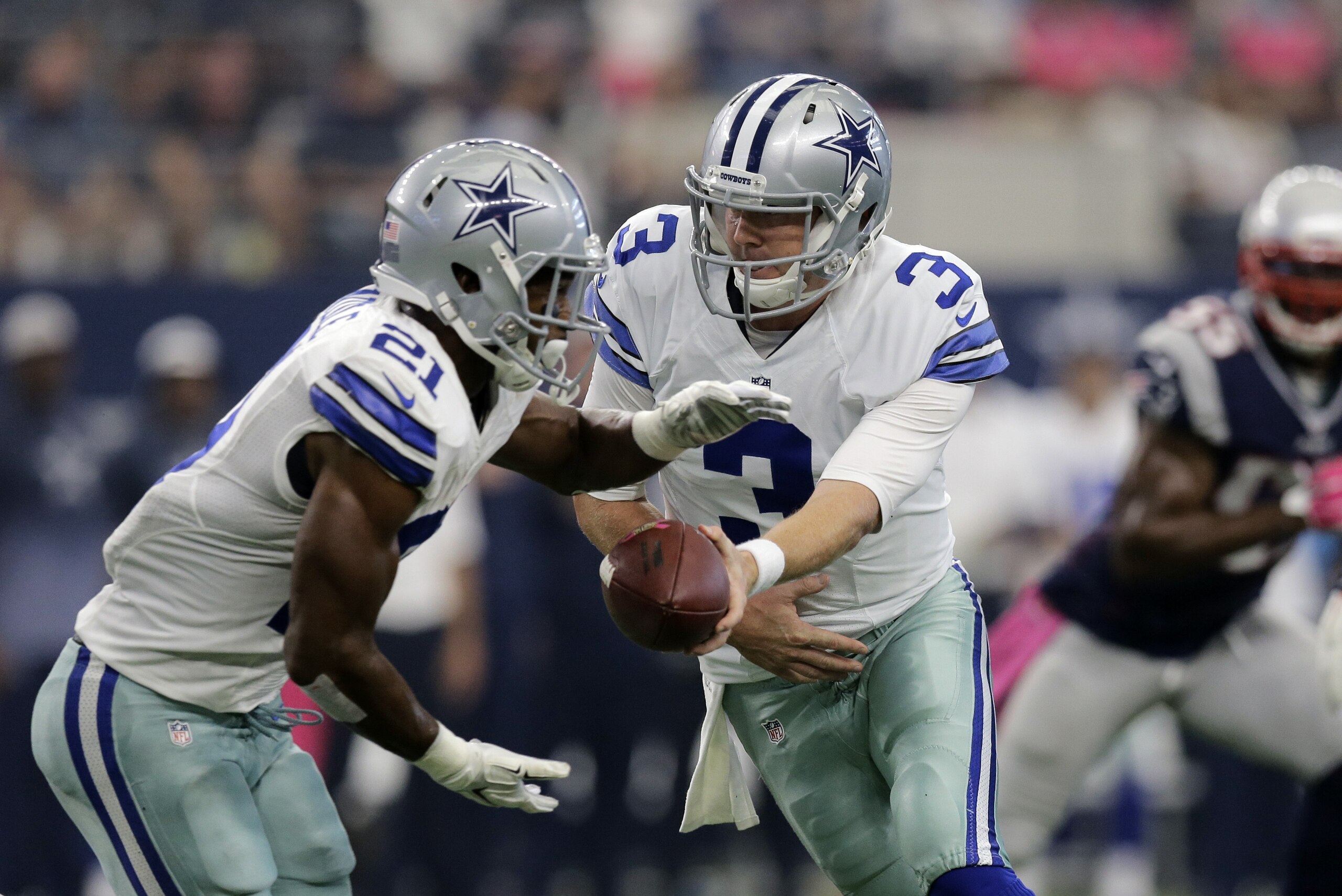 Dallas Cowboys' Brandon Weeden (3) hands off to Joseph Randle (21) during the first quarter of an NFL football game against the New England Patriots, Sunday, Oct. 11, 2015, in Arlington, Texas. (AP Photo/Tim Sharp)
