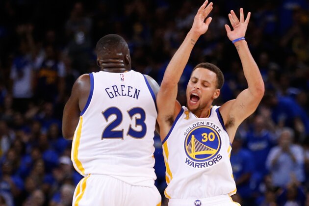 OAKLAND, CA - OCTOBER 27:  Stephen Curry #30 of the Golden State Warriors celebrates with Draymond Green #23 after a three point basket against the New Orleans Pelicans during the NBA season opener at ORACLE Arena on October 27, 2015 in Oakland, California. NOTE TO USER: User expressly acknowledges and agrees that, by downloading and or using this photograph, User is consenting to the terms and conditions of the Getty Images License Agreement.  (Photo by Ezra Shaw/Getty Images)