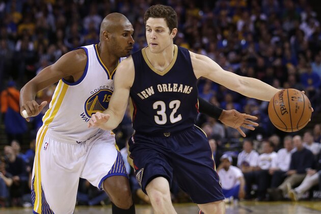 New Orleans Pelicans' Jimmer Fredette (32) is defended by Golden State Warriors' Leandro Barbosa during the first half of an NBA basketball game Friday, March 20, 2015, in Oakland, Calif. (AP Photo/Marcio Jose Sanchez)