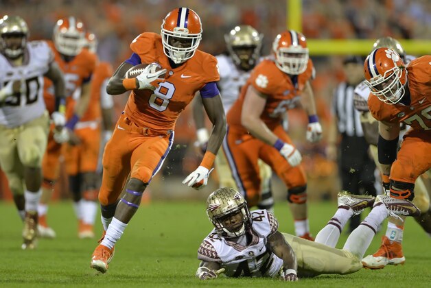 Clemson's Deon Cain (8) rushes out of the tackle attempt by Florida State's Lamarcus Brutus on his way to a touchdown during the second half of an NCAA college football game Saturday, Nov. 7, 2015,  in Clemson,  S.C.  Clemson won 23-13. (AP Photo/Richard Shiro)