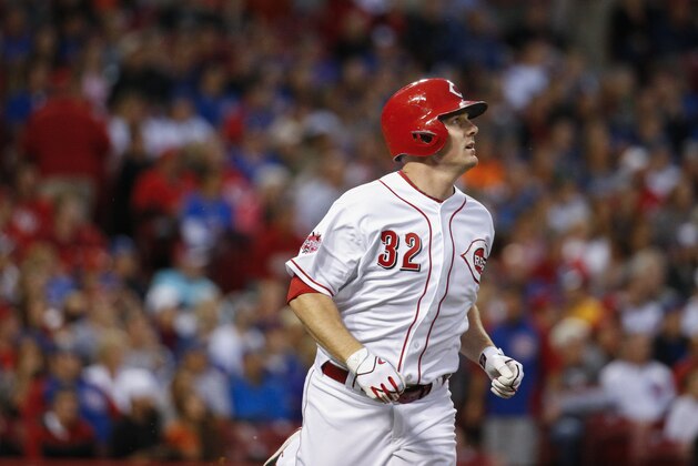 Cincinnati Reds' Jay Bruce watches the ball after hitting an RBI sacrifice fly off Chicago Cubs starting pitcher Jon Lester (34) in the first inning of a baseball game, Wednesday, Sept. 30, 2015, in Cincinnati. The Cubs won 10-3. (AP Photo/John Minchillo)