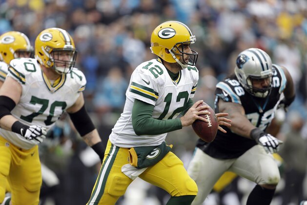 Green Bay Packers' Aaron Rodgers (12) scrambles, looking for an open receiver  against the Carolina Panthers during the second half of an NFL football game in Charlotte, N.C., Sunday, Nov. 8, 2015. The Panthers won 37-29. (AP Photo/Bob Leverone)