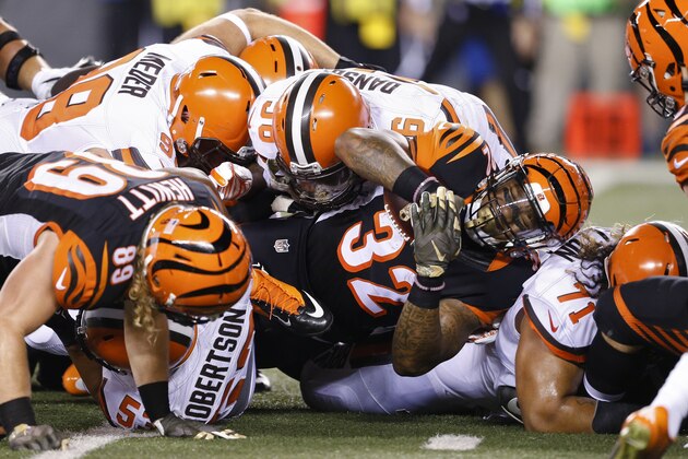 Cincinnati Bengals running back Jeremy Hill (32) is tackled on a run during the first half of an NFL football game against the Cleveland Browns, Thursday, Nov. 5, 2015, in Cincinnati. (AP Photo/Gary Landers)