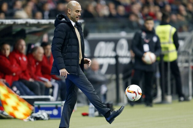 Bayern Munich coach Pep Guardiola controls the ball,  during a German Bundesliga soccer match between Eintracht Frankfurt and Bayern Munich in Frankfurt, Germany, Friday, Oct. 30, 2015. (AP Photo/Michael Probst)