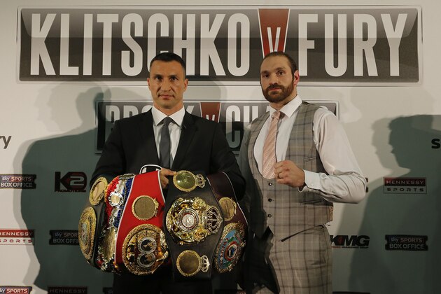 World Heavyweight boxing champion, Wladimir Klitschko, left, holding his title belts and British heavyweight Tyson Fury pose for photographers  during a press conference in London, Wednesday, Sept. 23, 2015. Klitschko will fight Fury in a heavyweight title bout on Oct. 24,  in Duesseldorf, Germany.(AP Photo/Frank Augstein)