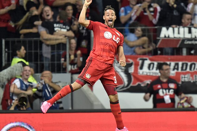 Leverkusen's Karim Bellarabi celebrates after scoring Leverkusen's third goal during the Champions League play-off 2nd leg soccer match between Bayer Leverkusen and Lazio Rome, in Leverkusen, Germany, Wednesday, Aug. 26, 2015. Leverkusen defeated Lazio with 3-0 and advanced to the Champions League Group stage. (AP Photo/Martin Meissner)