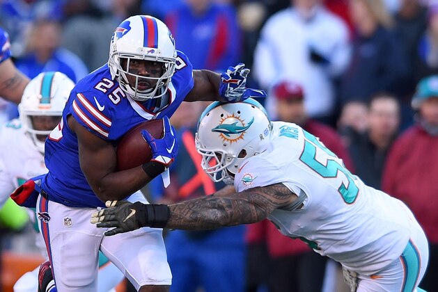 ORCHARD PARK, NY - NOVEMBER 08:   LeSean McCoy #25 of the Buffalo Bills breaks a tackle by  Koa Misi #55 of the Miami Dolphins during the second half at Ralph Wilson Stadium on November 8, 2015 in Orchard Park, New York.  (Photo by Rich Barnes/Getty Images)