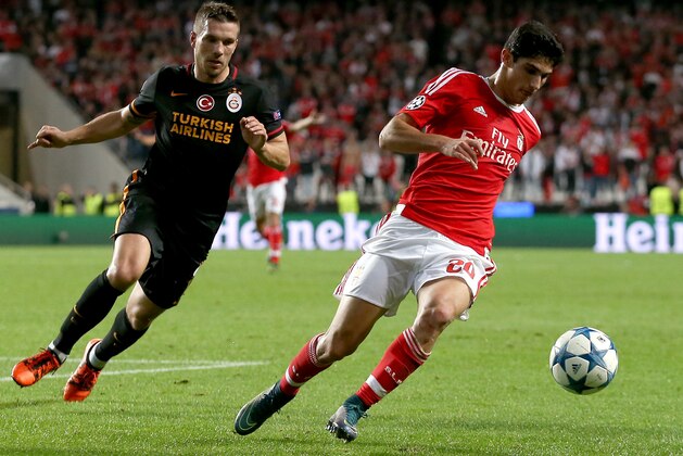 Benfica's Goncalo Guedes, right, and Galatasaray's Lukas Podolski, left, challenge for the ball during the Champions League group C soccer match between Benfica and Galatasaray at the Luz stadium in Lisbon, Portugal, Tuesday, Nov. 3, 2015.  (AP Photo/Armando Franca)
