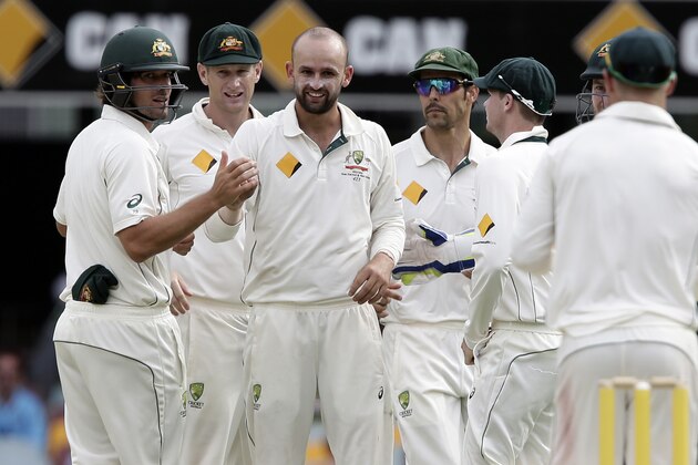 Australia's Nathan Lyon, center left, celebrates after getting the wicket of New Zealand's Kane Williamson during play on day four of the first cricket test between Australia and New Zealand in Brisbane, Australia, Sunday, Nov. 8, 2015. (AP Photo/Tertius Pickard)