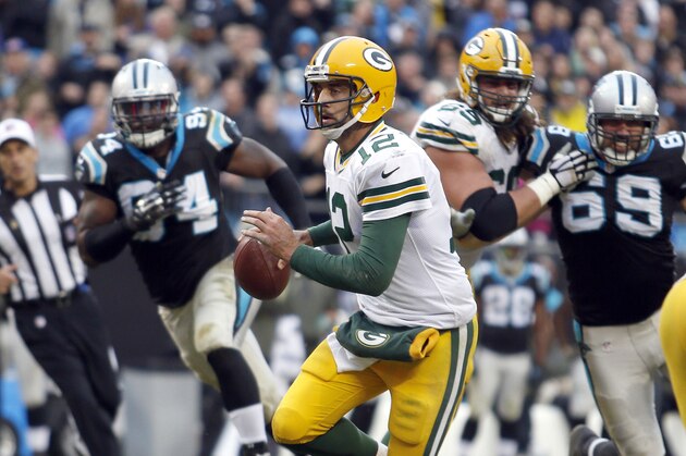 Green Bay Packers' Aaron Rodgers (12) scrambles away from the Carolina Panthers defense during the second half of an NFL football game in Charlotte, N.C., Sunday, Nov. 8, 2015. The Panthers won 37-29. (AP Photo/Bob Leverone)