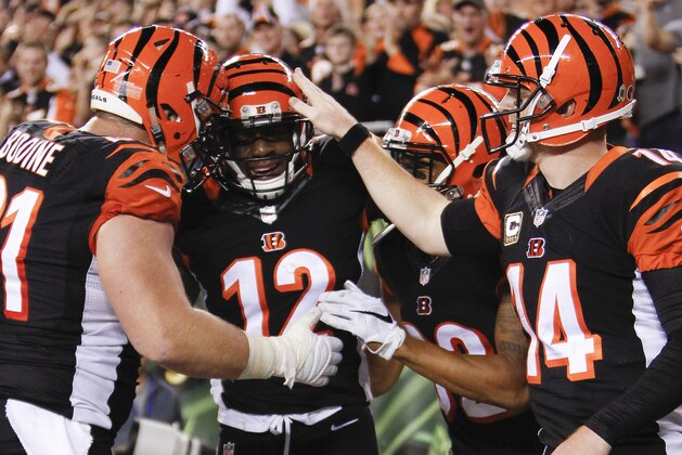Cincinnati Bengals wide receiver Mohamed Sanu (12) celebrates after scoring a touchdown with center Russell Bodine (61) and quarterback Andy Dalton (14) during the second half of an NFL football game against the Cleveland Browns, Thursday, Nov. 5, 2015, in Cincinnati. (AP Photo/Frank Victores)