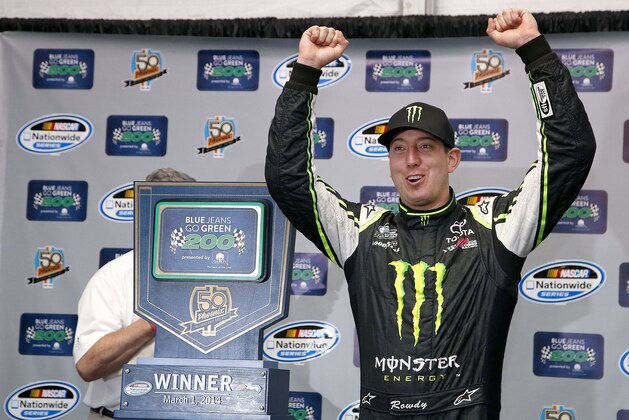 Kyle Busch poses for photographers after he won the rain-shortened NASCAR Nationwide Series auto race Saturday, March 1, 2014, in Avondale, Ariz. (AP Photo/Ross D. Franklin)