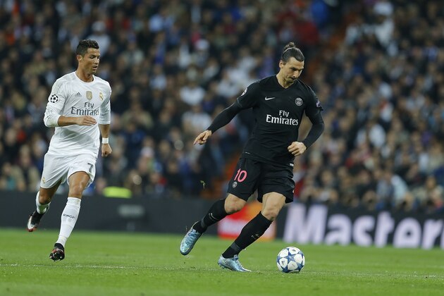 PSG's Zlatan Ibrahimovic, right, controls the ball as Real Madrid's Cristiano Ronaldo looks on during the Champions League group A soccer match between Real Madrid and PSG at the Santiago Bernabeu stadium in Madrid, Tuesday, Nov. 3, 2015. (AP Photo/Francisco Seco)