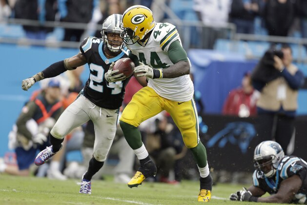 The Green Bay Packers' James Starks (44) tries to run away from Carolina Panthers' Josh Norman (24) during the second half of an NFL football game in Charlotte, N.C., Sunday, Nov. 8, 2015. The Panthers won 37-29. (AP Photo/Bob Leverone)