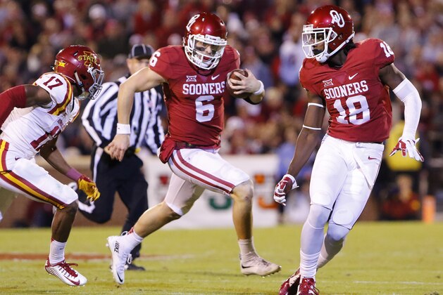 Oklahoma quarterback Baker Mayfield (6) runs ahead of Iowa State defensive back Jomal Wiltz (17) as Oklahoma wide receiver Dahu Green (18) looks to block during the third quarter of an NCAA college football game in Norman, Okla., on Saturday, Nov. 7, 2015. Oklahoma won 52-16. (AP Photo/Alonzo Adams)