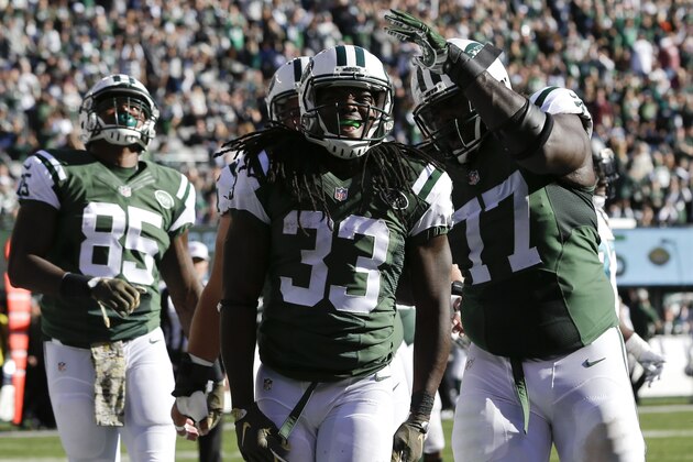 New York Jets running back Chris Ivory (33) celebrates with guard James Carpenter (77) after scoring a touchdown against the Jacksonville Jaguars during the first quarter of an NFL football game, Sunday, Nov. 8, 2015, in East Rutherford, N.J. (AP Photo/Seth Wenig)