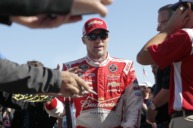 Kevin Harvick walks during introductions before the NASCAR Sprint Cup Series auto race at Texas Motor Speedway in Fort Worth, Texas, Sunday, Nov. 8, 2015. (AP Photo/Ralph Lauer)