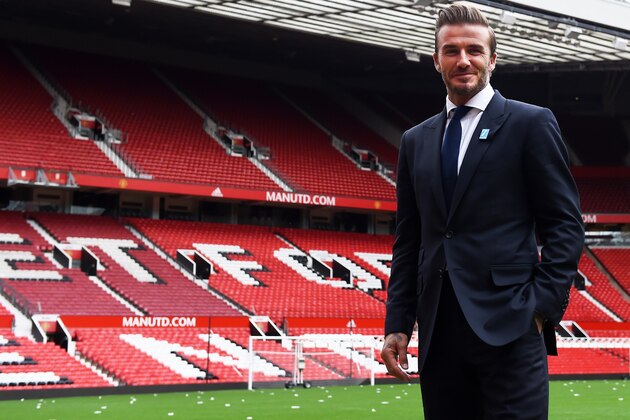 Former Manchester United and England footballer David Beckham poses on the pitch at Old Trafford in Manchester, north west England on October 6, 2015 ahead of a charity football match in aid of UNICEF. Beckham will lead the Great Britain and Ireland team against a Rest of the World team led by Zinedine Zidane at Old Trafford on November 14.
 AFP PHOTO/PAUL ELLIS        (Photo credit should read PAUL ELLIS/AFP/Getty Images)