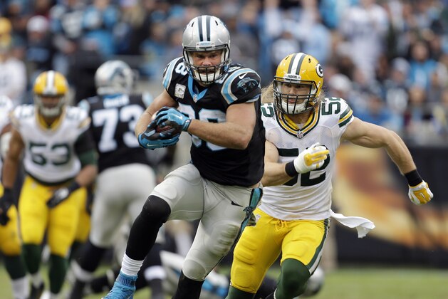 After making the catch, the Carolina Panthers' Greg Olsen (88) runs away from Green Bay Packers' Clay Matthews (52) during the second half of an NFL football game in Charlotte, N.C., Sunday, Nov. 8, 2015. The Panthers won 37-29. (AP Photo/Bob Leverone)