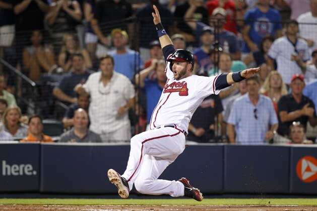 Atlanta Braves' A.J. Pierzynski slides home safely on a single by Eury Perez during the eighth inning of a baseball game against the Chicago Cubs, Friday, July 17, 2015, in Atlanta. The Braves won 4-2. (AP Photo/Brett Davis)