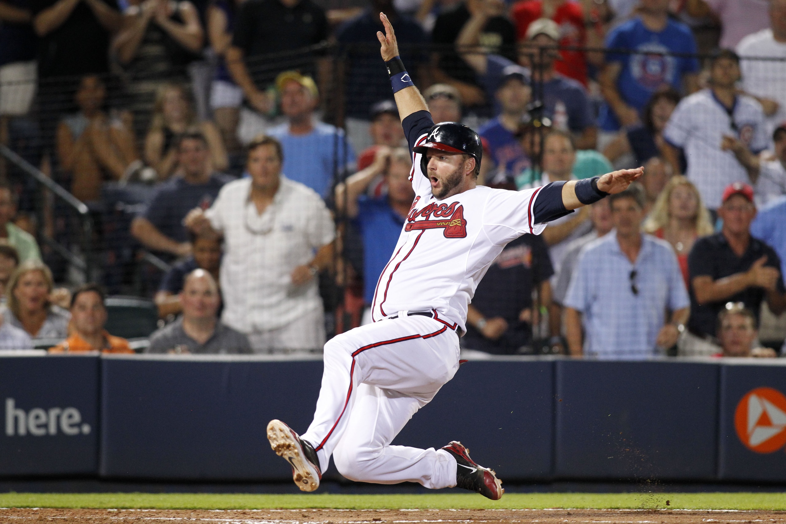 Atlanta Braves' A.J. Pierzynski slides home safely on a single by Eury Perez during the eighth inning of a baseball game against the Chicago Cubs, Friday, July 17, 2015, in Atlanta. The Braves won 4-2. (AP Photo/Brett Davis)