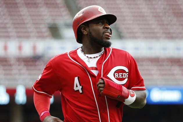 Cincinnati Reds' Brandon Phillips runs back to the dugout after being tagged out by Chicago Cubs second baseman Addison Russell when he slipped a lead toward home in the sixth inning of a baseball game, Thursday, Oct. 1, 2015, in Cincinnati. The Cubs won 5-3. (AP Photo/John Minchillo)