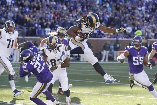 St. Louis Rams running back Todd Gurley (30) leaps over Minnesota Vikings cornerback Terence Newman (23) during the second half of an NFL football game, Sunday, Nov. 8, 2015, in Minneapolis. (AP Photo/Ann Heisenfelt)
