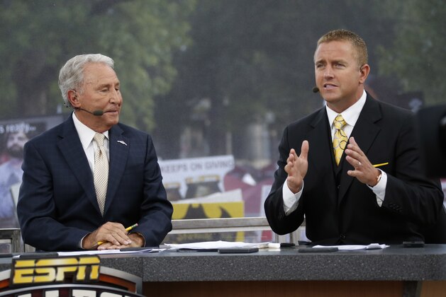 ESPN College GameDay hosts Lee Corso, left, listens to Kirk Herbstreit during the telecast from The Junction prior to Mississippi State playing Auburn in an NCAA college football game in Starkville, Miss., Saturday, Oct 11, 2014. No.3 Mississippi State beat No. 2 Auburn 38-23. (AP Photo/Rogelio V. Solis)