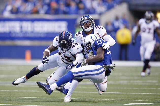 INDIANAPOLIS, IN - NOVEMBER 8: T.Y. Hilton #13 of the Indianapolis Colts takes a hard hit after a reception against Chris Harris Jr. #25 and T.J. Ward #43 of the Denver Broncos during a game at Lucas Oil Stadium on November 8, 2015 in Indianapolis, Indiana. The Colts defeated the Broncos 27-24. (Photo by Joe Robbins/Getty Images)
