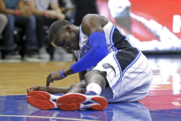 Orlando Magic guard Victor Oladipo gets up slowly after he was injured during the first half of an NBA basketball game against the Los Angeles Lakers, Wednesday, Nov. 11, 2015, in Orlando, Fla. (AP Photo/John Raoux)
