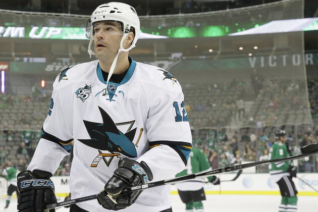 San Jose Sharks center Patrick Marleau (12) looks to give away a puck to a fan in the stands during warm ups before an NHL hockey game against the Dallas Stars Saturday, Oct. 31, 2015, in Dallas. (AP Photo/LM Otero)