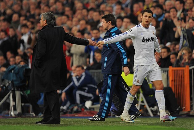 MADRID, SPAIN - MARCH 16: Cristiano Ronaldo (R) of Real Madrid shakes hands with head coach Jose Mourinho after being substituted during the UEFA Champions League round of 16 second leg match between Real Madrid and Lyon at Estadio Santiago Bernabeu on March 16, 2011 in Madrid, Spain.  (Photo by Denis Doyle/Getty Images)