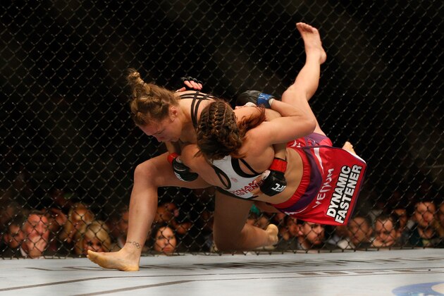 LAS VEGAS, NV - DECEMBER 28:  (L-R) Ronda Rousey throws Miesha Tate in their UFC women's bantamweight championship bout during the UFC 168 event at the MGM Grand Garden Arena on December 28, 2013 in Las Vegas, Nevada. (Photo by Josh Hedges/Zuffa LLC/Zuffa LLC via Getty Images)