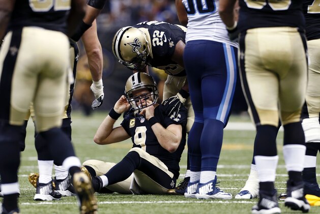 New Orleans Saints running back Mark Ingram (22) checks on quarterback Drew Brees (9) after he took a late hit in the second half of an NFL football game against the Tennessee Titans in New Orleans, Sunday, Nov. 8, 2015. (AP Photo/Jonathan Bachman)