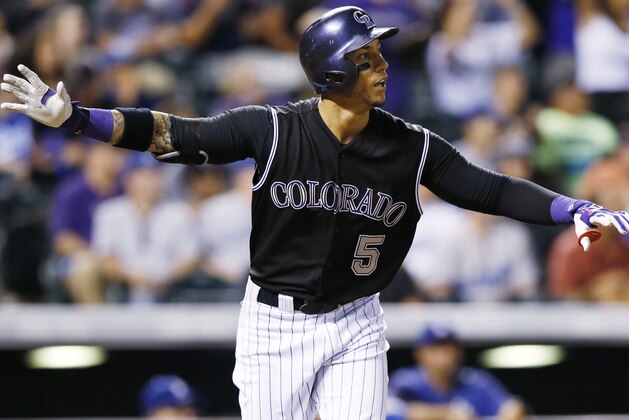 Colorado Rockies' Carlos Gonzalez follows the flight of his walkoff home run off Los Angeles Dodgers relief pitcher Yimi Garcia in the ninth inning of a baseball game Saturday, Sept. 26, 2015, in Denver. The Rockies won 8-6. (AP Photo/David Zalubowski)
