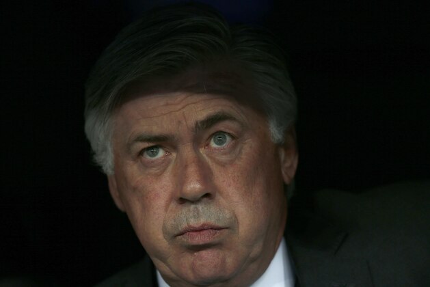Real Madrid's coach Carlo Ancelotti watches from the dugout during the Champions League second leg semifinal soccer match between Real Madrid and Juventus, at the Santiago Bernabeu stadium in Madrid, Wednesday, May 13, 2015. (AP Photo/Daniel Ochoa de Olza)