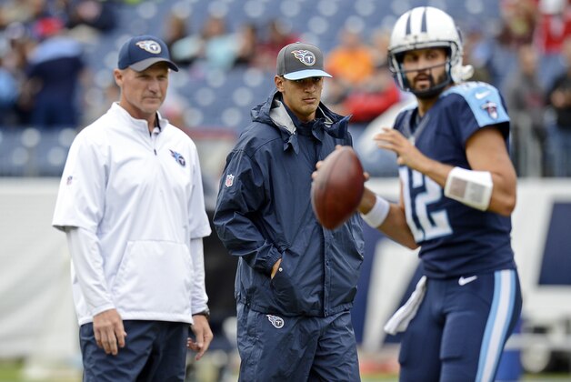 Injured Tennessee Titans quarterback Marcus Mariota, center watches with head coach Ken Whisenhunt, left, as quarterback Charlie Whitehurst (12) warms up  before an NFL football game between the Titans and the Atlanta Falcons Sunday, Oct. 25, 2015, in Nashville, Tenn. (AP Photo/Mark Zaleski)