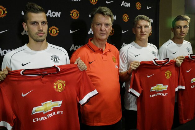 Manchester United manager Louis van Gaal, second from left, stands with new singings Morgan Schneiderlin, left, Bastian Schweinsteiger, second from right, and Matteo Darmian during a press conference, Wednesday, July 15, 2015, in Bellevue, Wash. Manchester United is in Seattle for an international friendly soccer match against Mexico's Club America to be played on Friday. (AP Photo/Ted S. Warren)