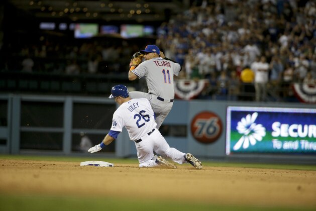 New York Mets shortstop Ruben Tejada, right, spins behind Los Angeles Dodgers' Chase Utley, left, who broke up a double play during the seventh inning in Game 2 of baseball's National League Division Series, Saturday, Oct. 10, 2015 in Los Angeles. (AP Photo/Gregory Bull) New York Mets shortstop Ruben Tejada, right, spins behind Los Angeles Dodgers' Chase Utley, left, who broke up a double play during the seventh inning in Game 2 of baseball's National League Division Series, Saturday, Oct. 10, 2015 in Los Angeles. (AP Photo/Gregory Bull)